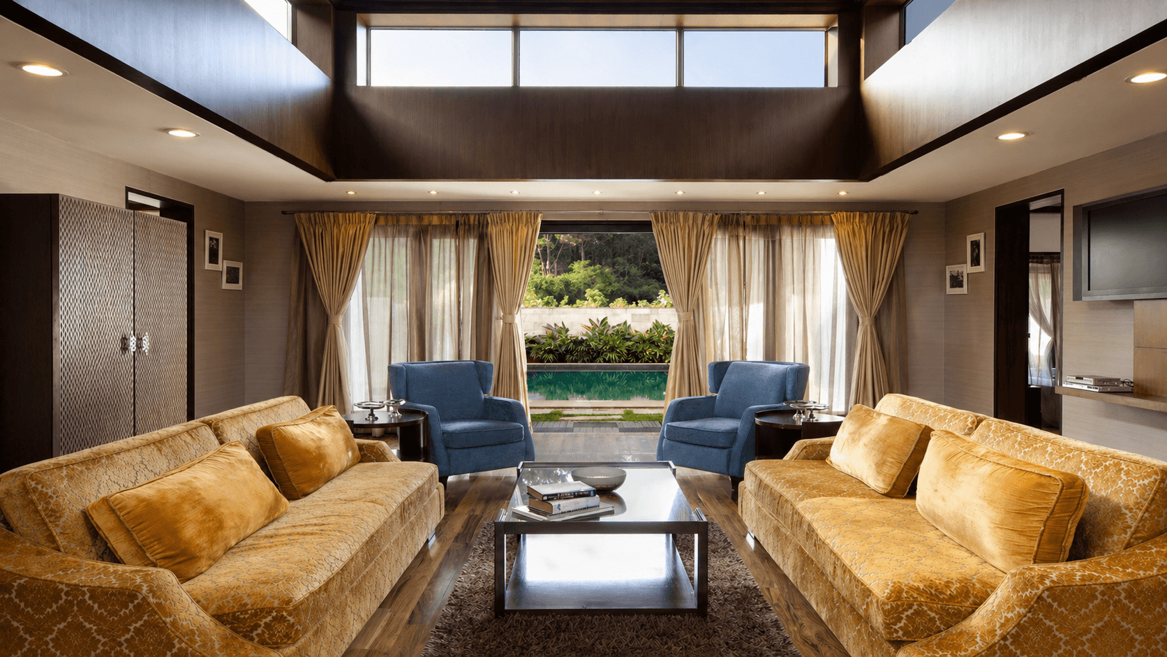 Sunlit beige living room with white sofa, artwork.