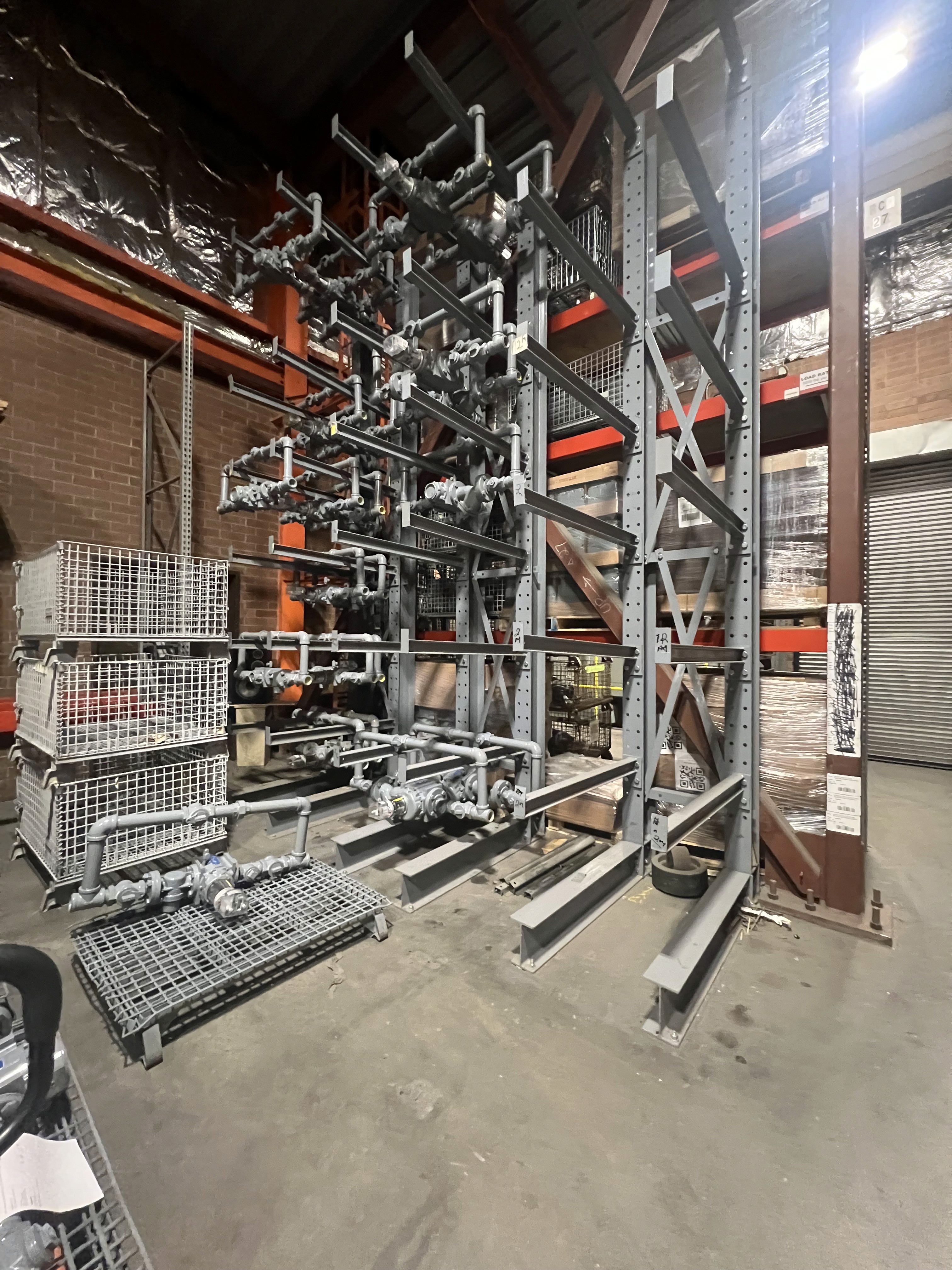 Low angle view of a modern white and orange building under the bright sky