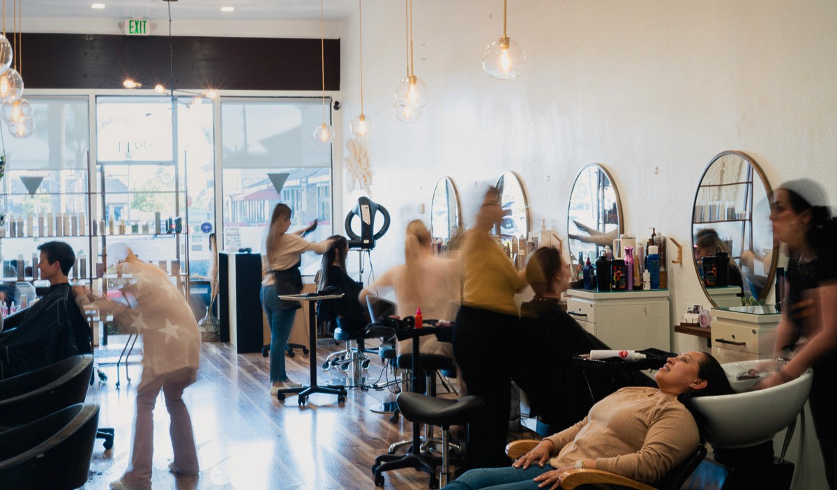 Stylists busy at work at Del Sol Hair Studio salon floor in Huntington Beach