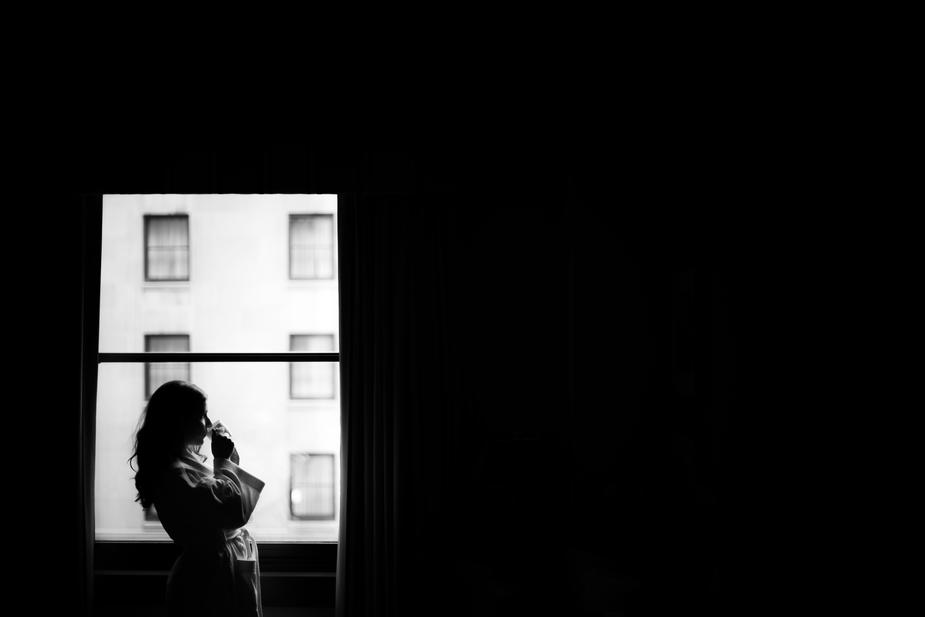woman at window with morning coffee 925x