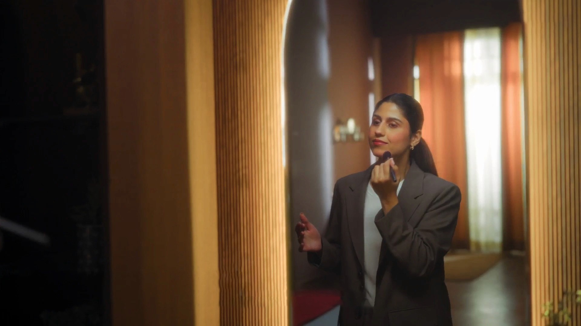 Woman getting ready in a mirror in a lifestyle shot for a TOTO India product video.