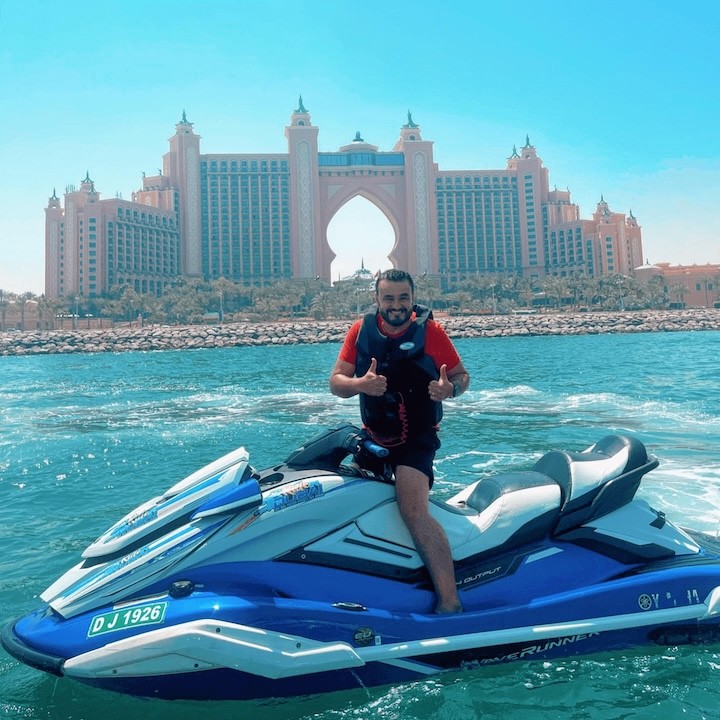Smiling rider posing on jet ski during their Atlantis Tour Dubai