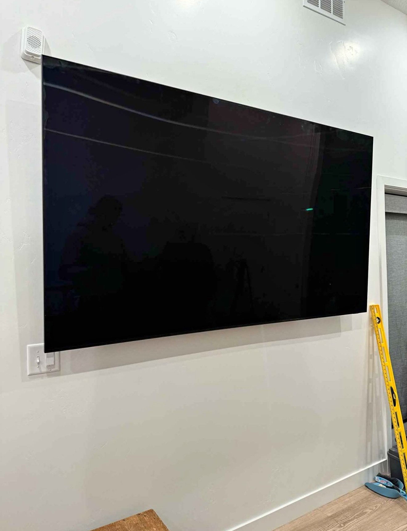 75-inch TV mounted using a standard wall mount setup in a residential home in Tampa, with clean wiring and a modern look.