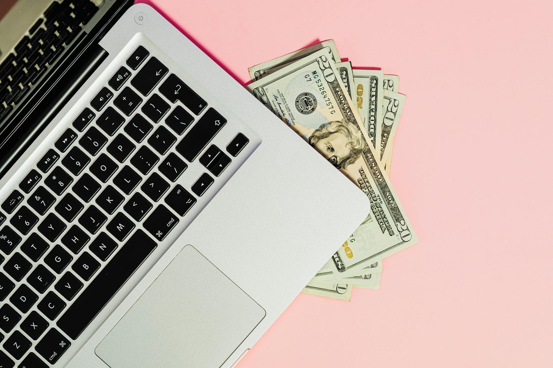 Photo by Karola G: https://www.pexels.com/photo/dollars-under-laptop-5706023/ 