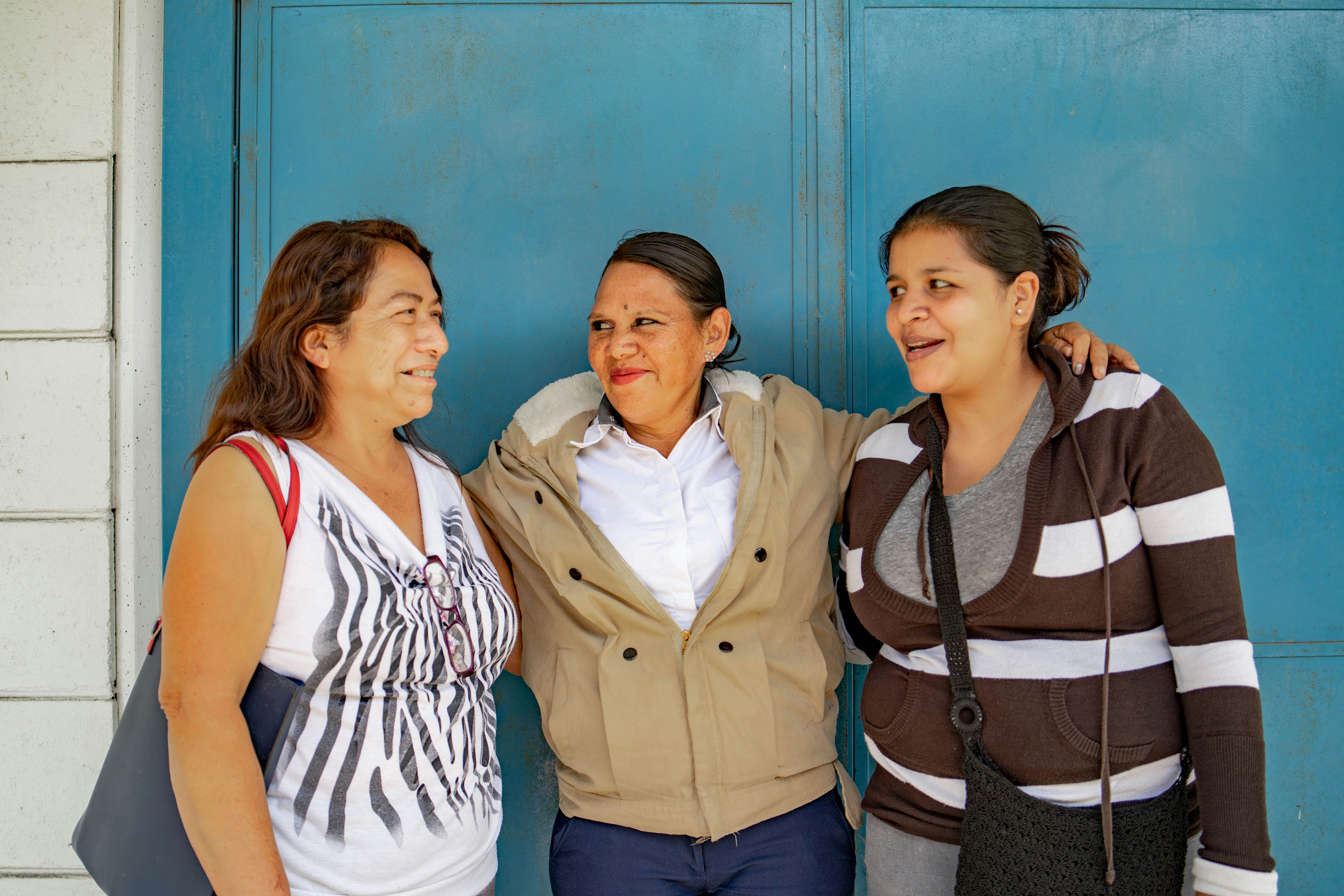 A group of three women standing next to each other