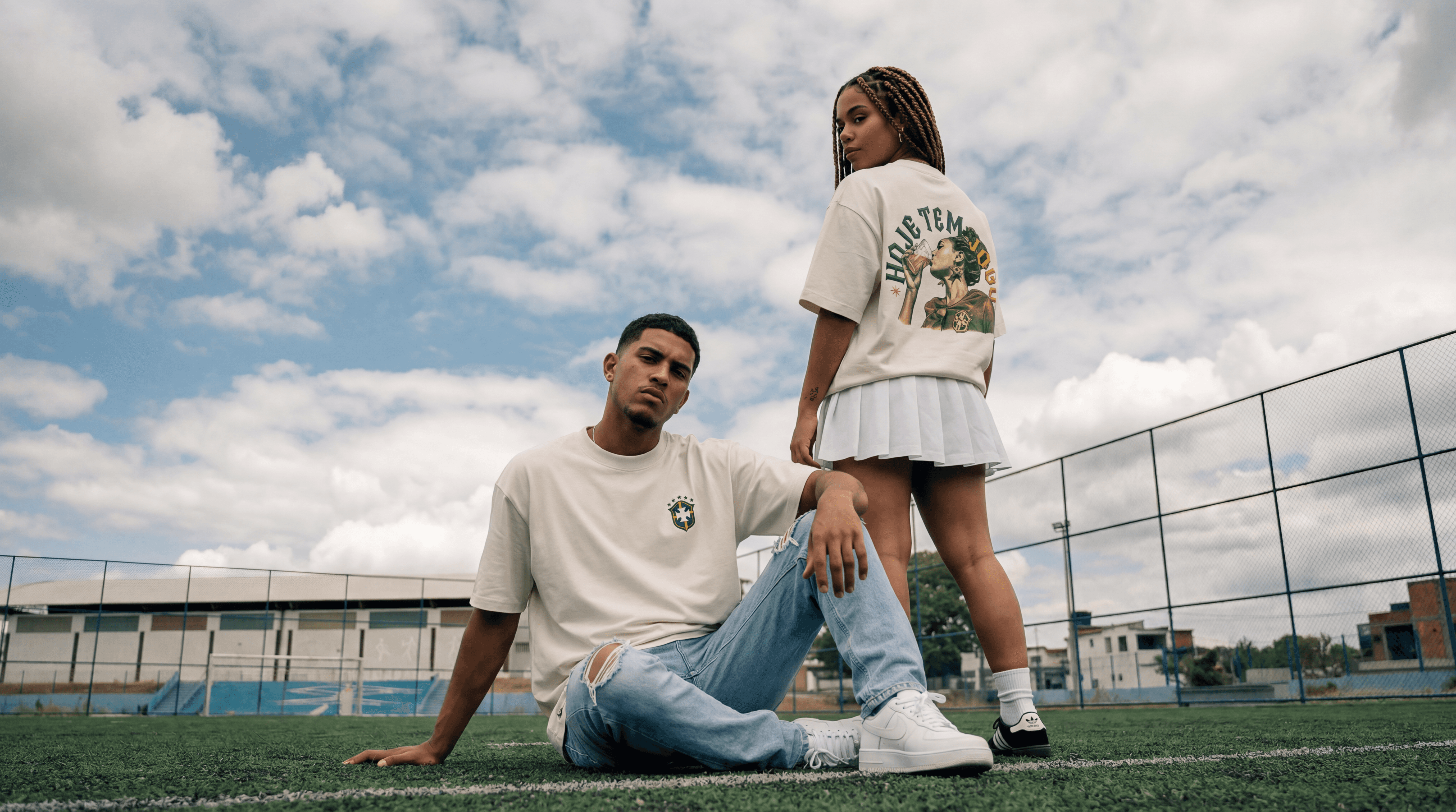 Young man in black leather double-breasted jacket jeans stand by white wall