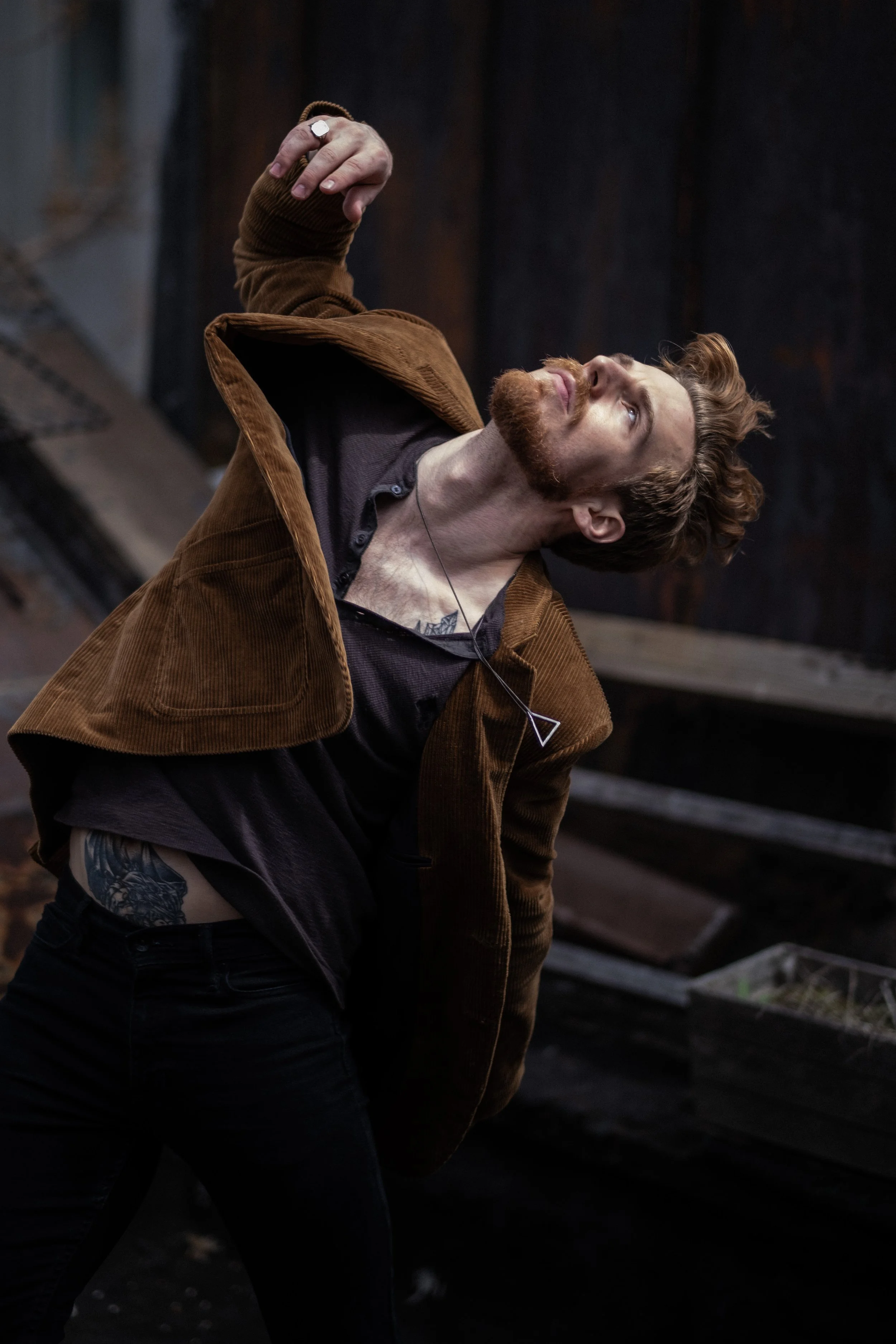 auburn-bearded man in the corduroy jacket, head tipped back dancin