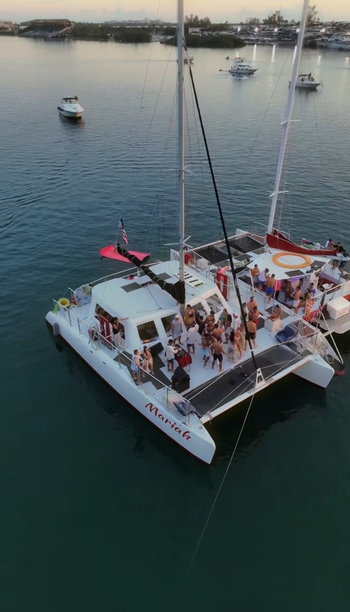 man standing near cliff looking at body of water during daytime