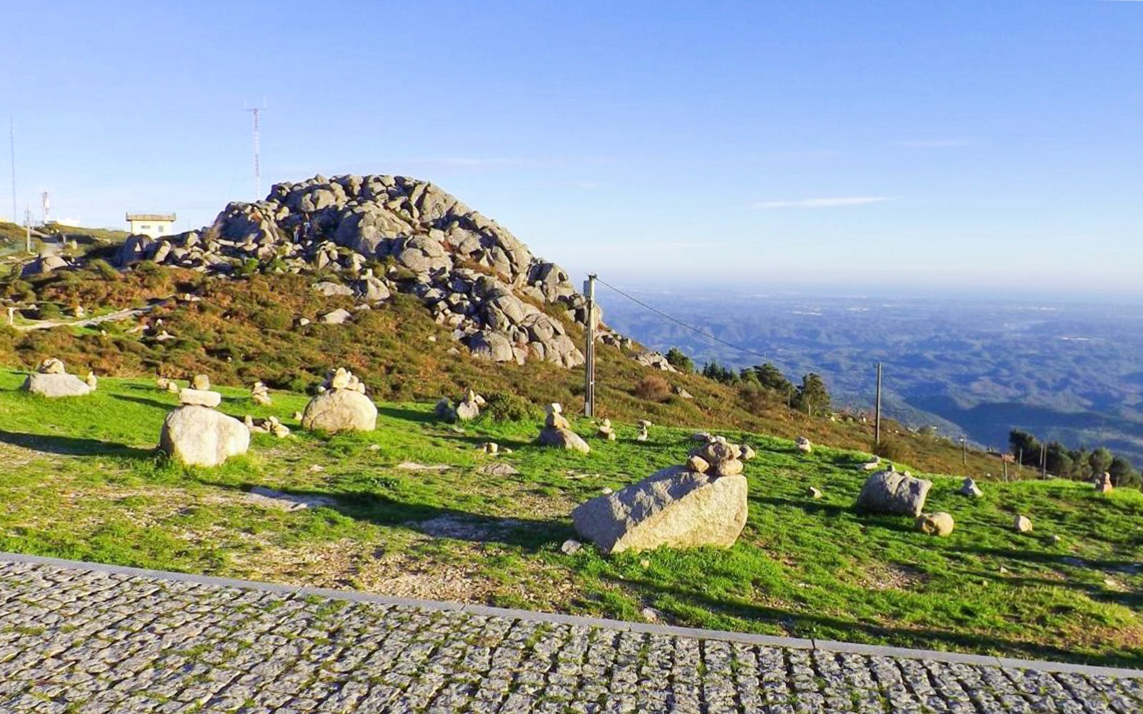 Rocky landscape with stone cairns on a hill in Western Algarve, Portugal.