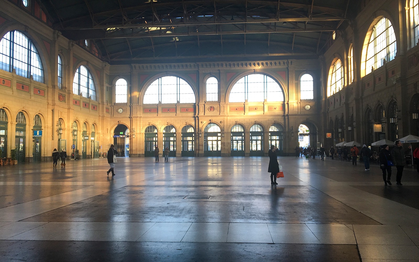 Zurich train station interior with travelers walking through the spacious hall.