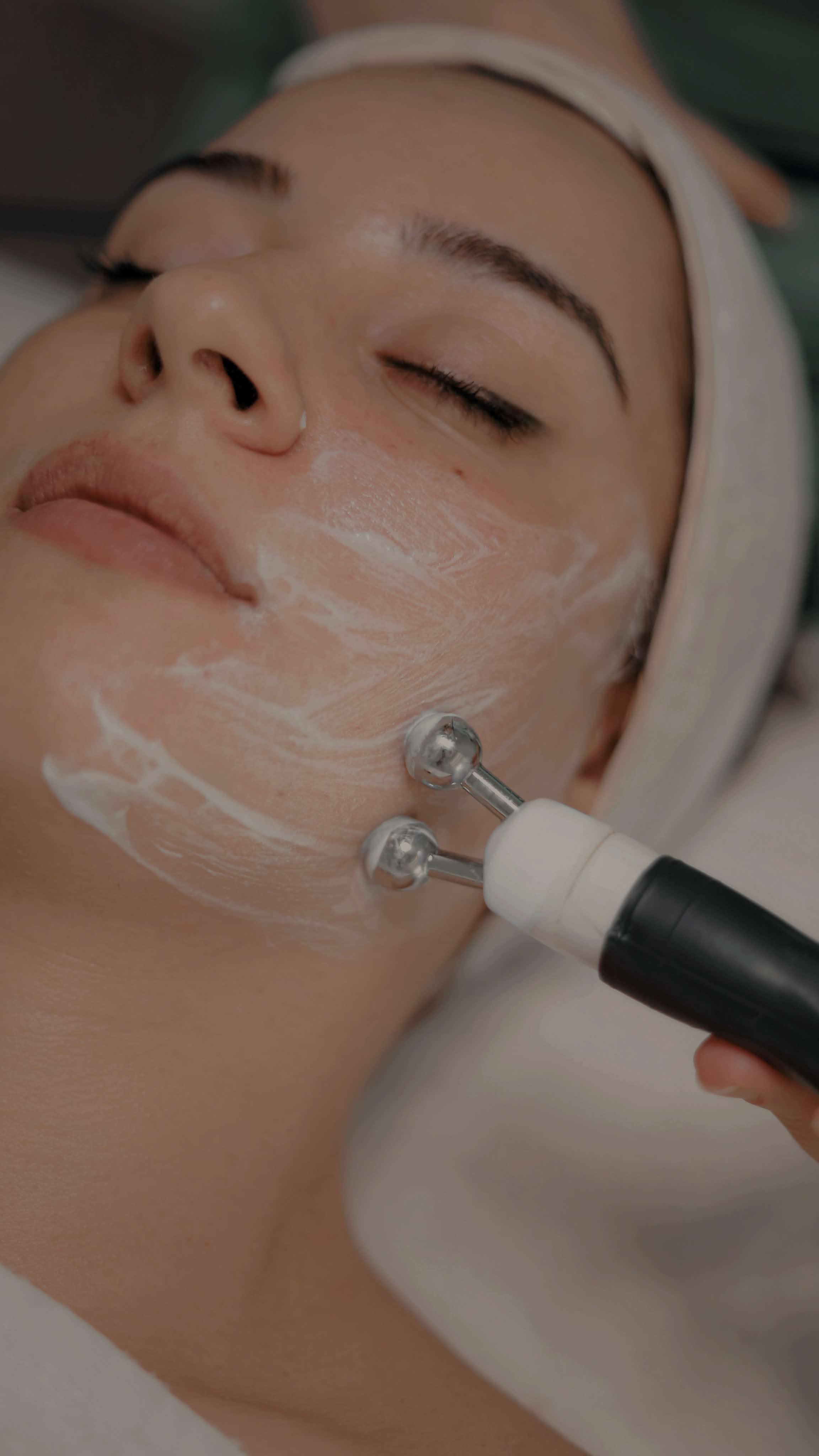 Professional facial treatment using cosmetic device in modern aesthetic clinic