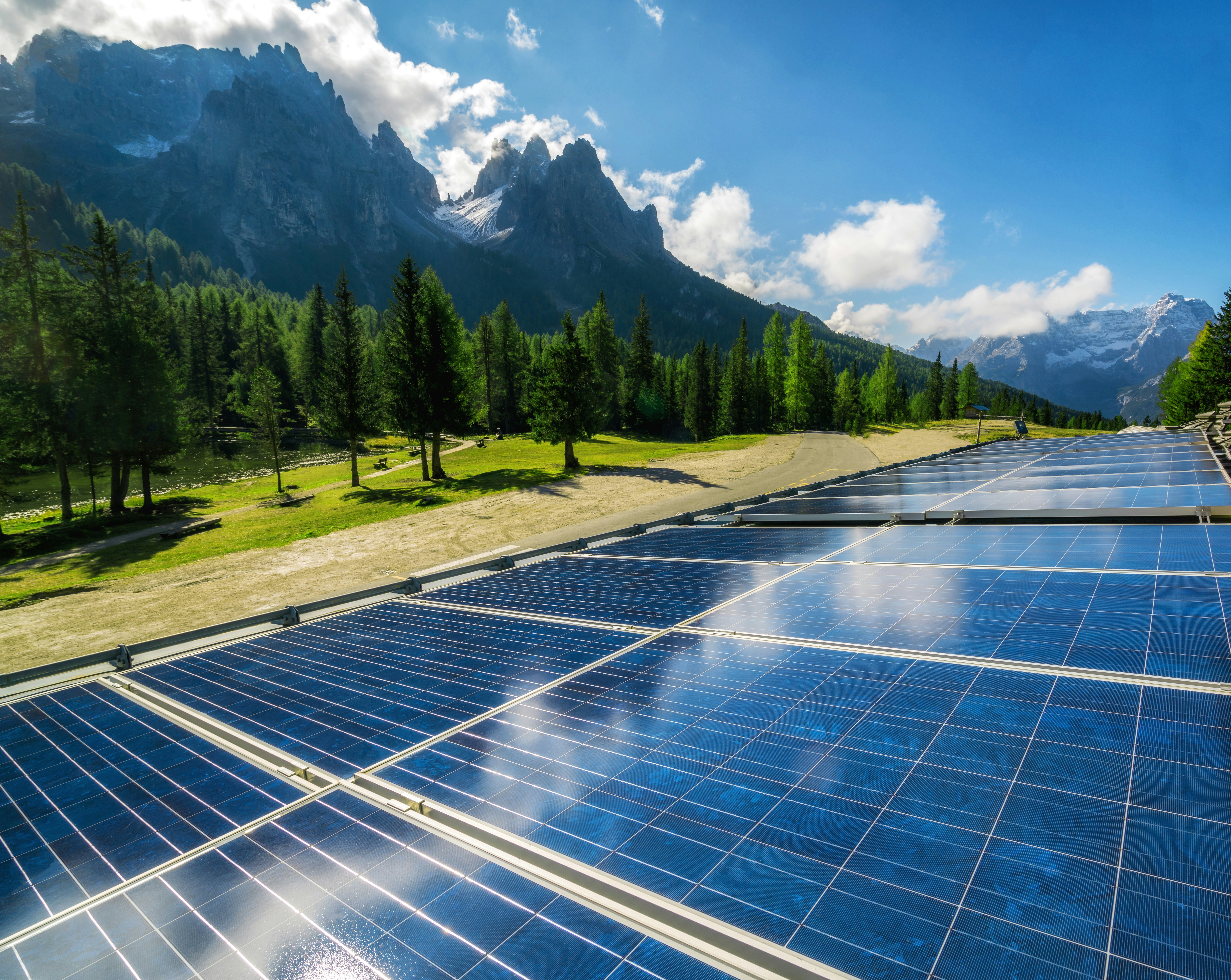 Vast solar farm with rolling hills and blue sky
