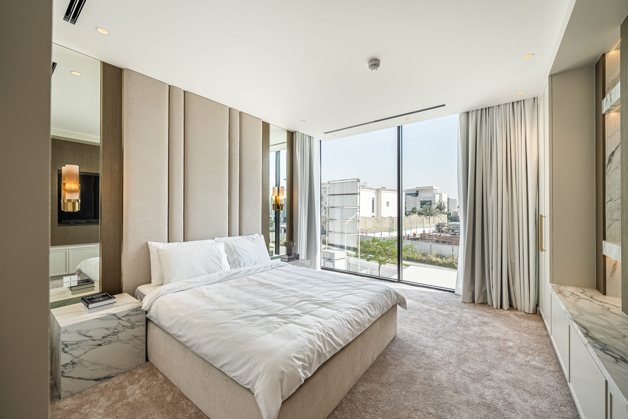 Image of a bedroom & a big glass window 