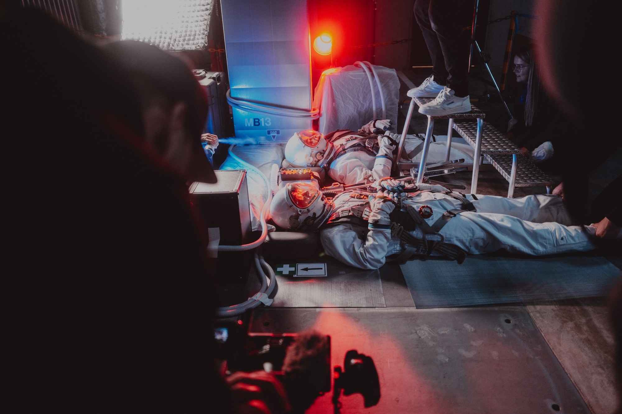 Person stand in front of a red sports oldtimer