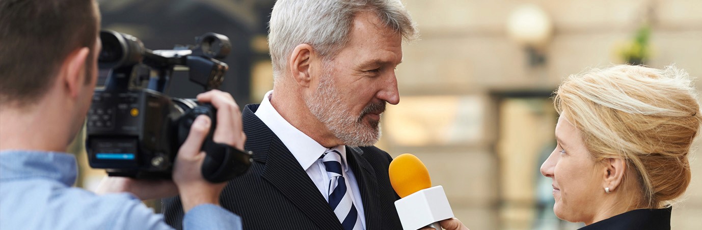 Mid age man giving an interview on the street