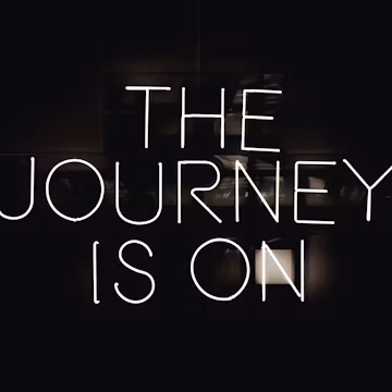 a black and white photo with the words the journey is on