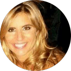 woman in black long sleeve shirt wearing black framed eyeglasses standing near green plants during daytime