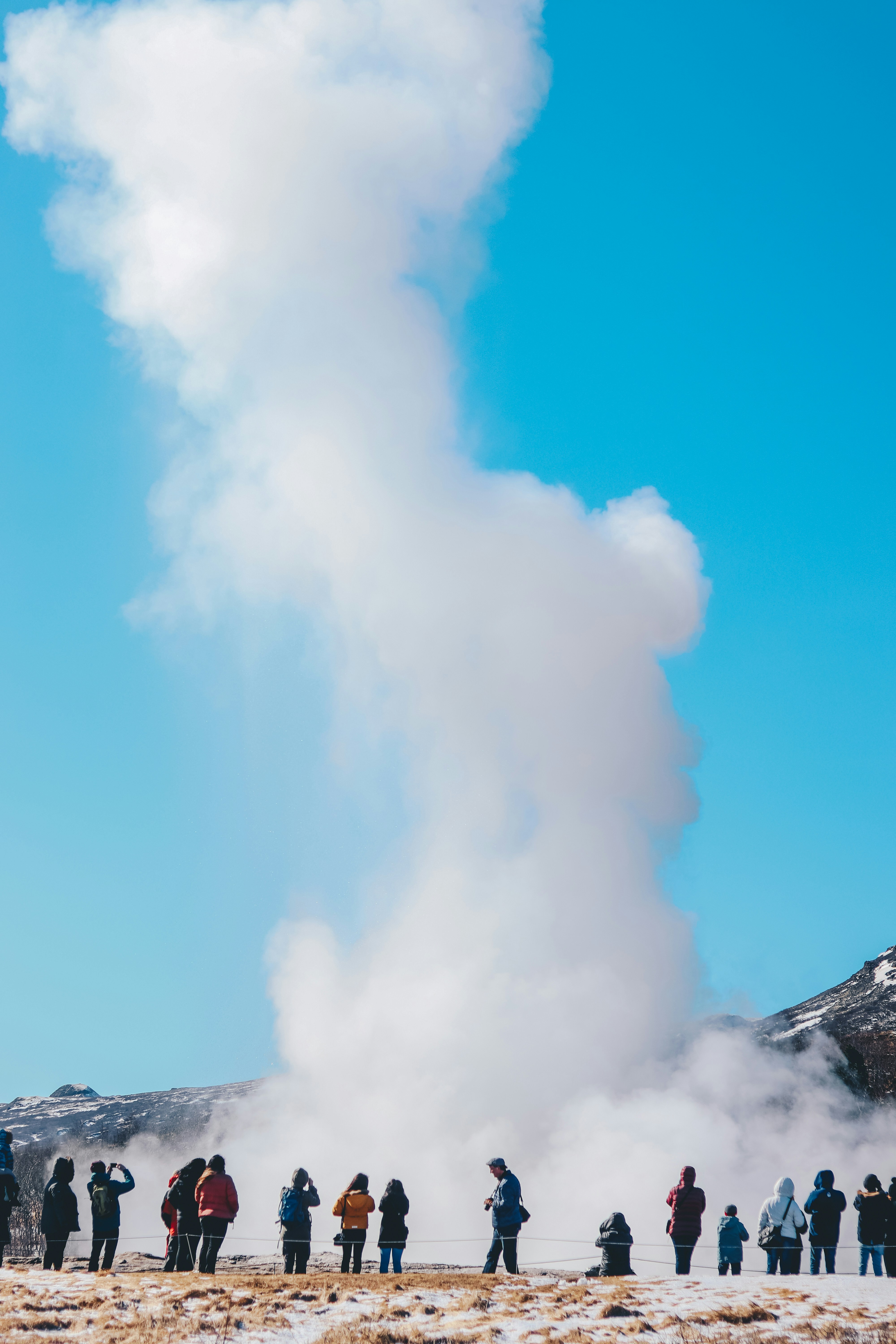 Tourists watching Geysir eruption in Iceland 