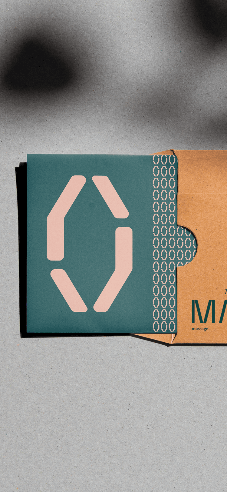 Luxury packaging design for Maison MANAO featuring a geometric logo on a green and kraft paper envelope