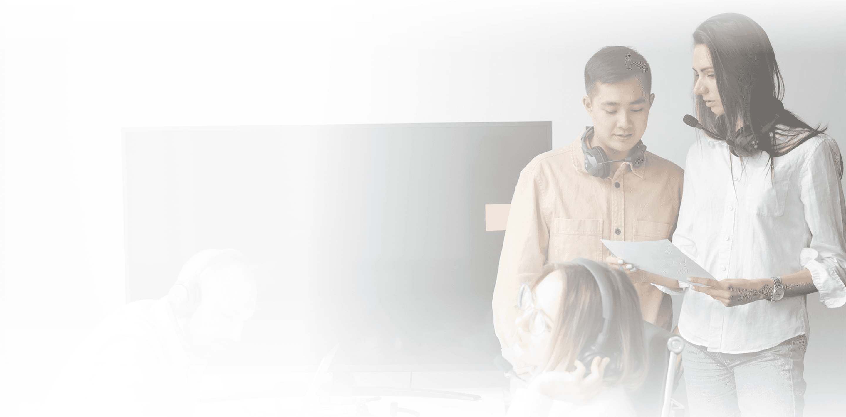 Team collaborating around a computer in an office.