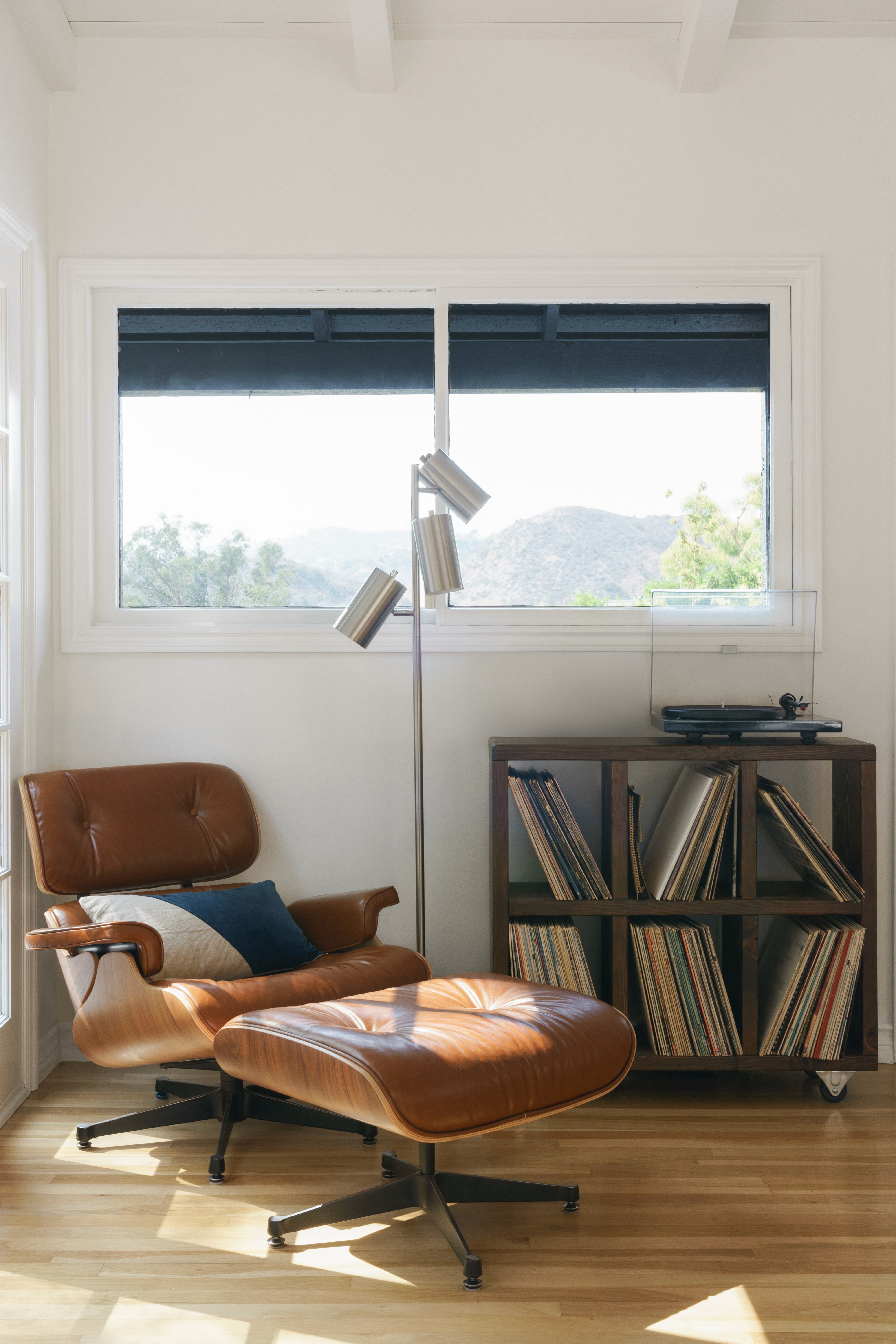 Mid-century living room Eames chair with a blend of classic design and contemporary comfort  by Ventura & Los Angeles interior designer Jubilee Interiors