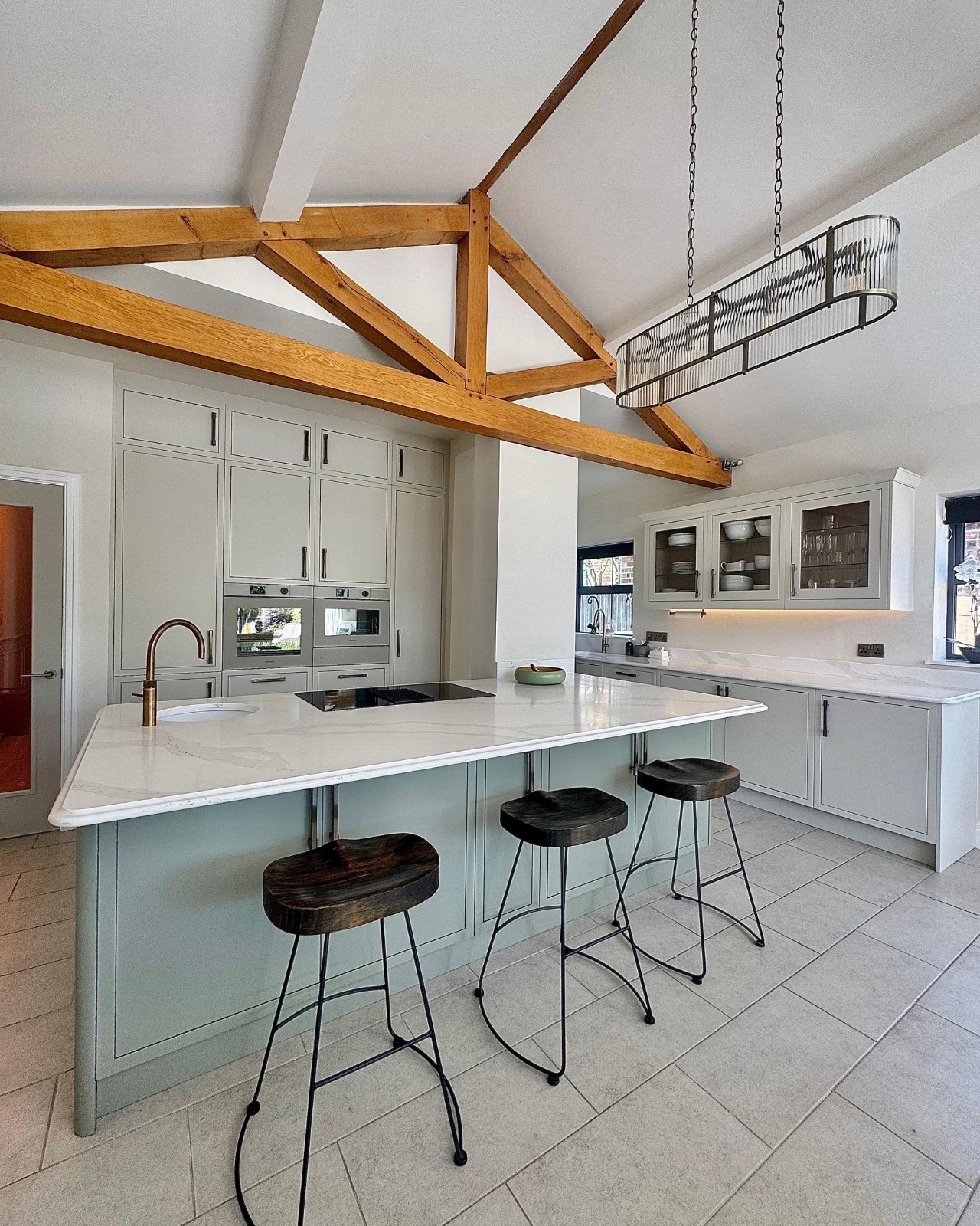 White bespoke kitchen under exposed oak roof beams