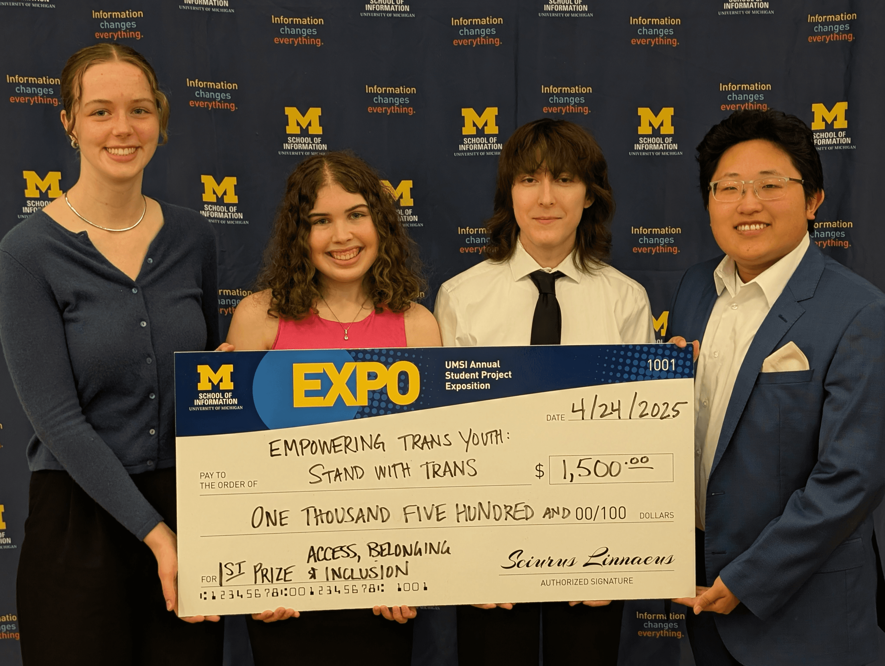 Sarah Penrose and team holding a large check for $1,500.