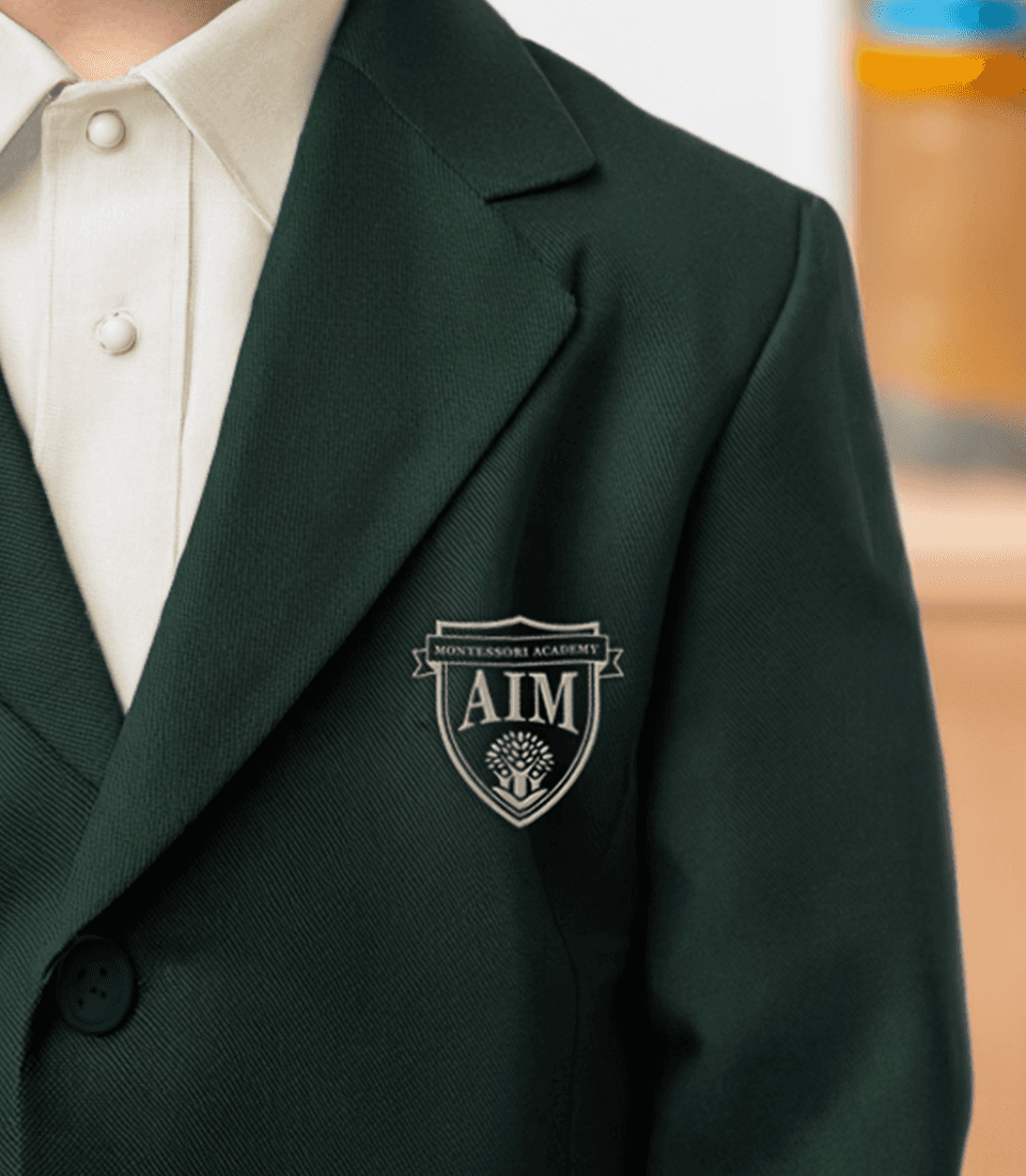 The Aim Montessori Academy crest embroidered on a jacket