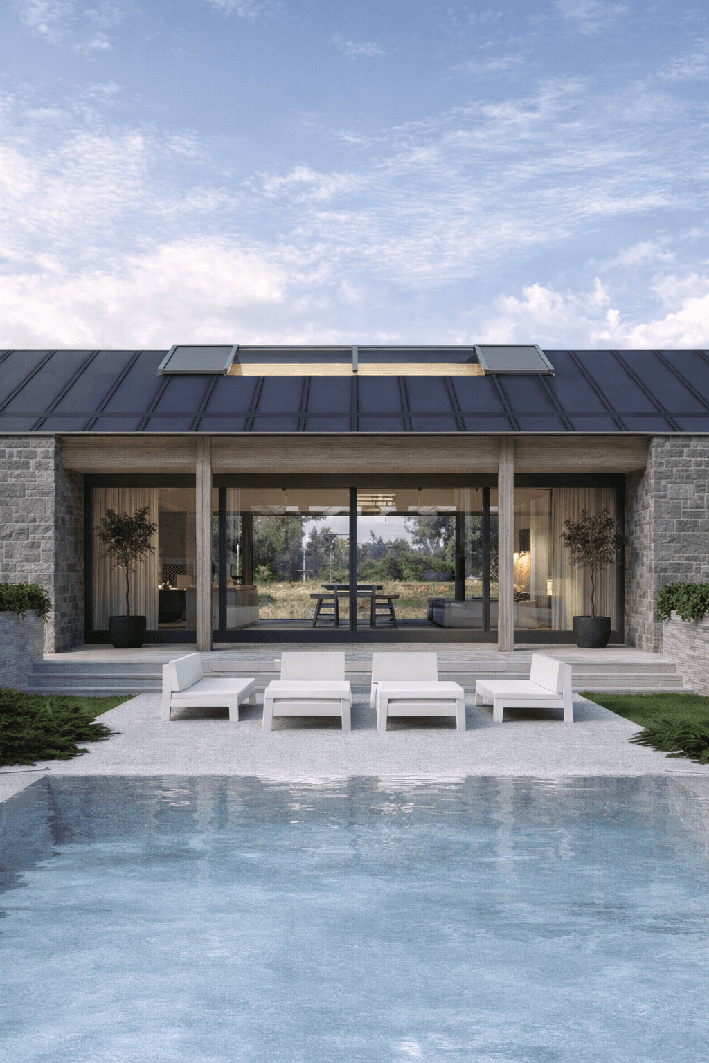 Terras met zwembad en zitgedeelte onder overstek, verbonden met de woonruimte via grote glaspuien. moderne schuurwoning