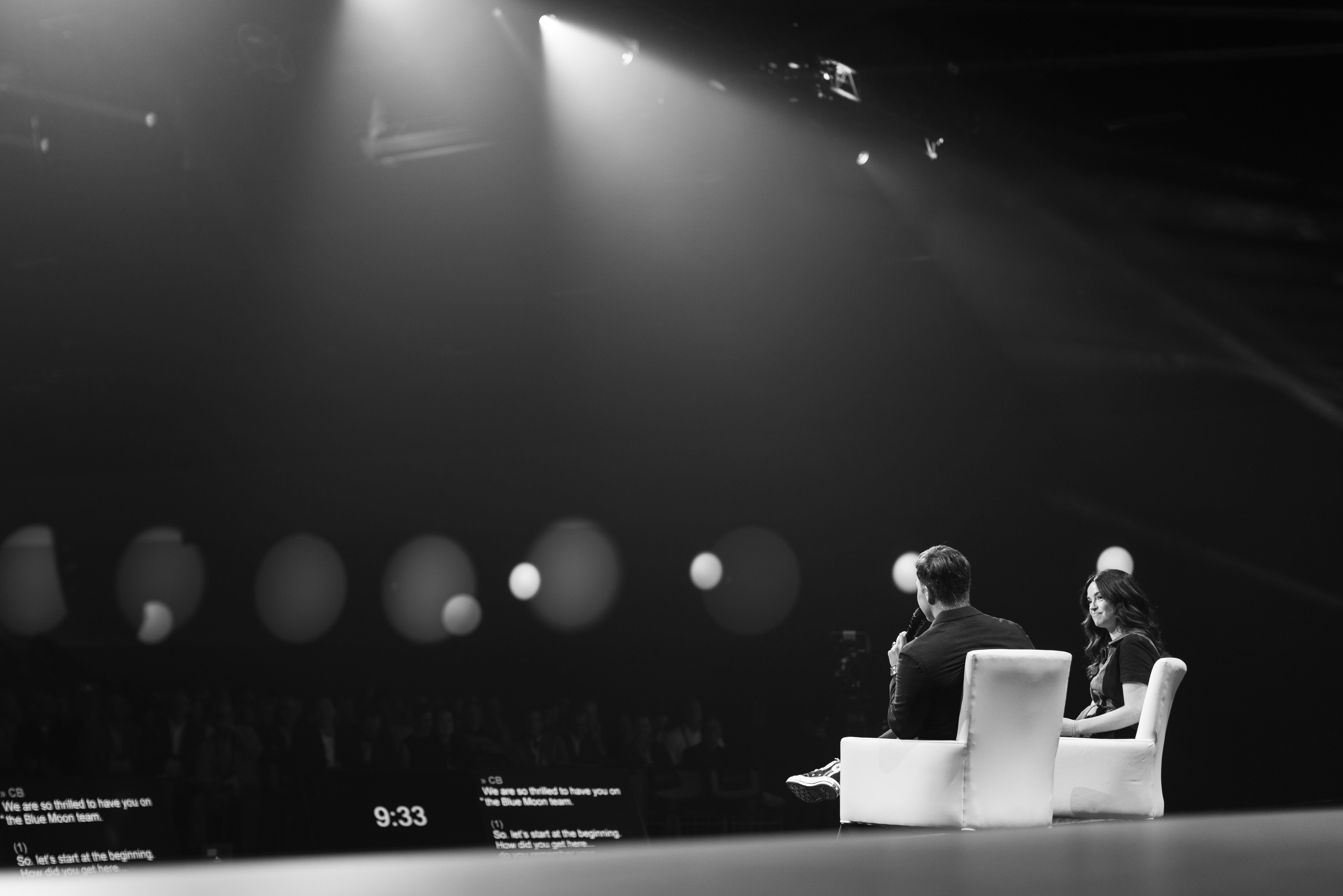  Collaborative work session overhead view of six people collaborating at a rustic wooden table with coffee, papers, and a laptop