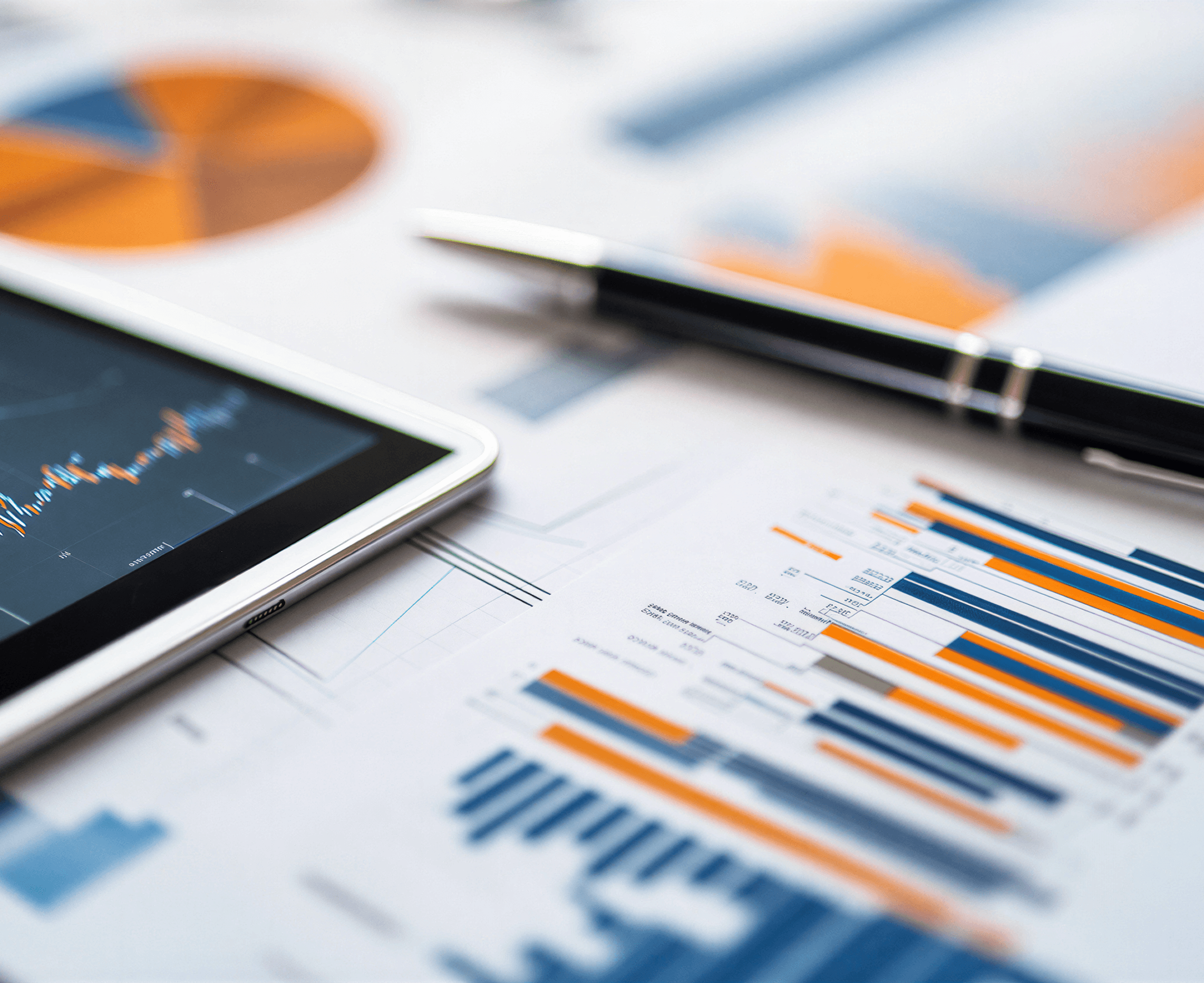 Business analytics and stock market graphs on office desk