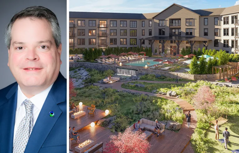 Tall modern skyscraper with vertical lines, viewed against a clear blue sky.