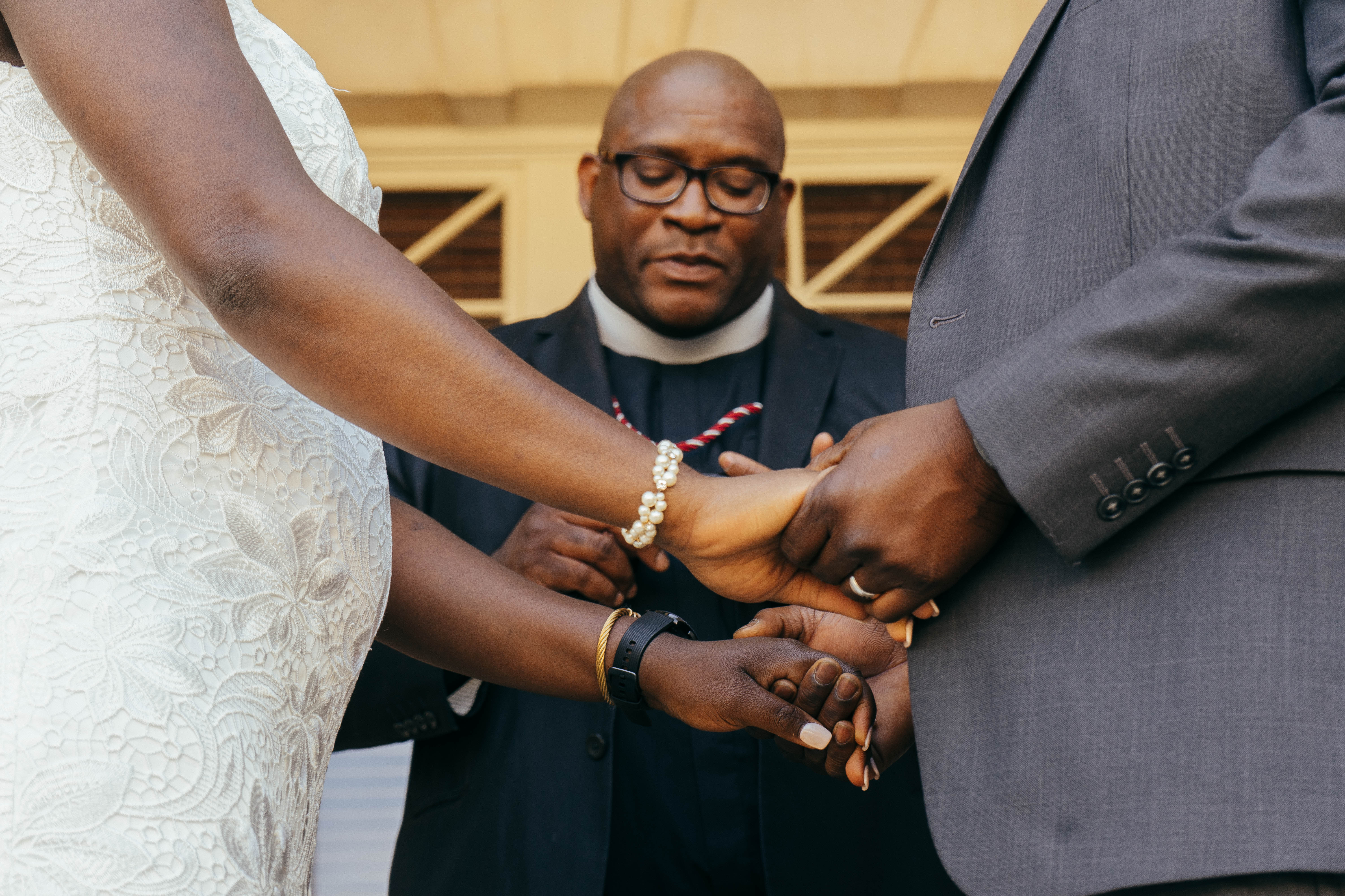 A couple in formal wedding attire embraces intimately in a vast.