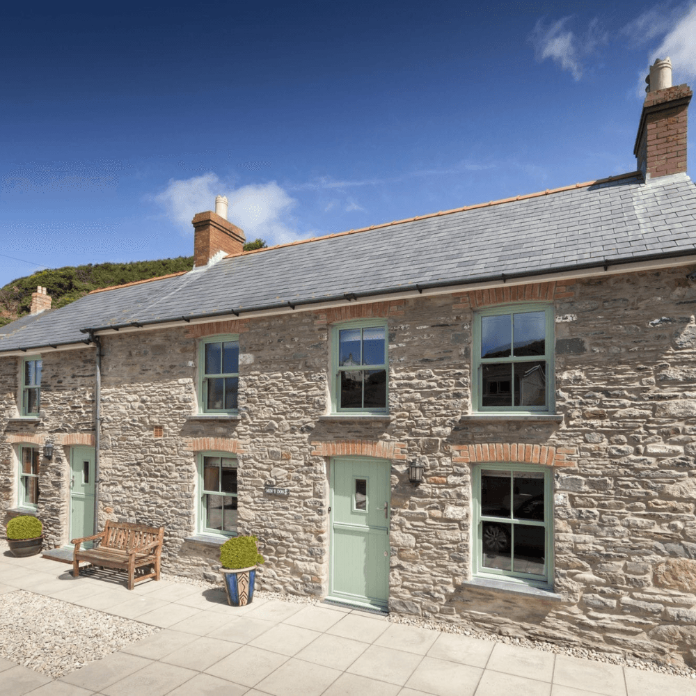 Traditional Yorkshire stone cottage with heritage-style windows in a conservation setting