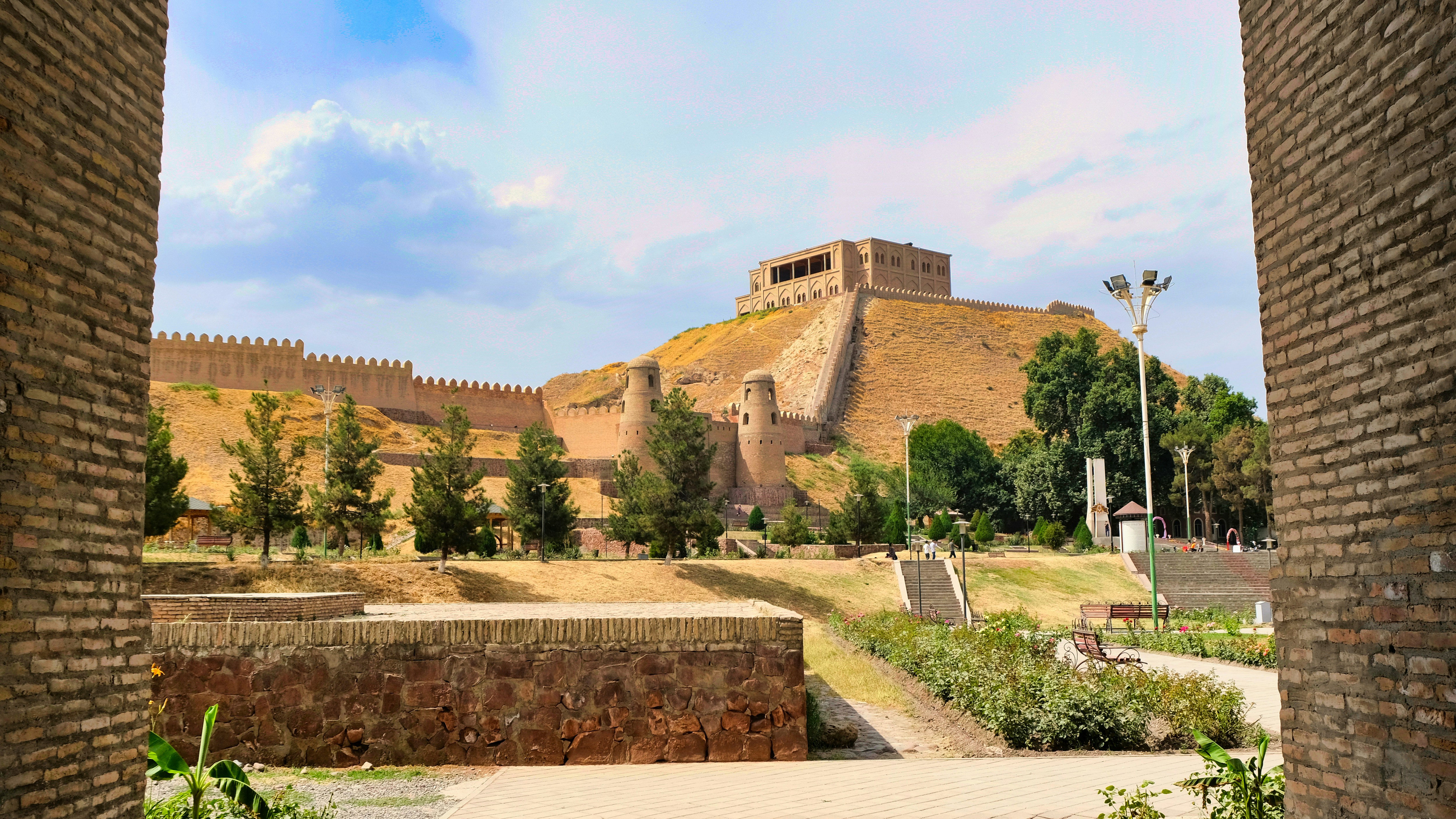 a view of a castle through two brick walls