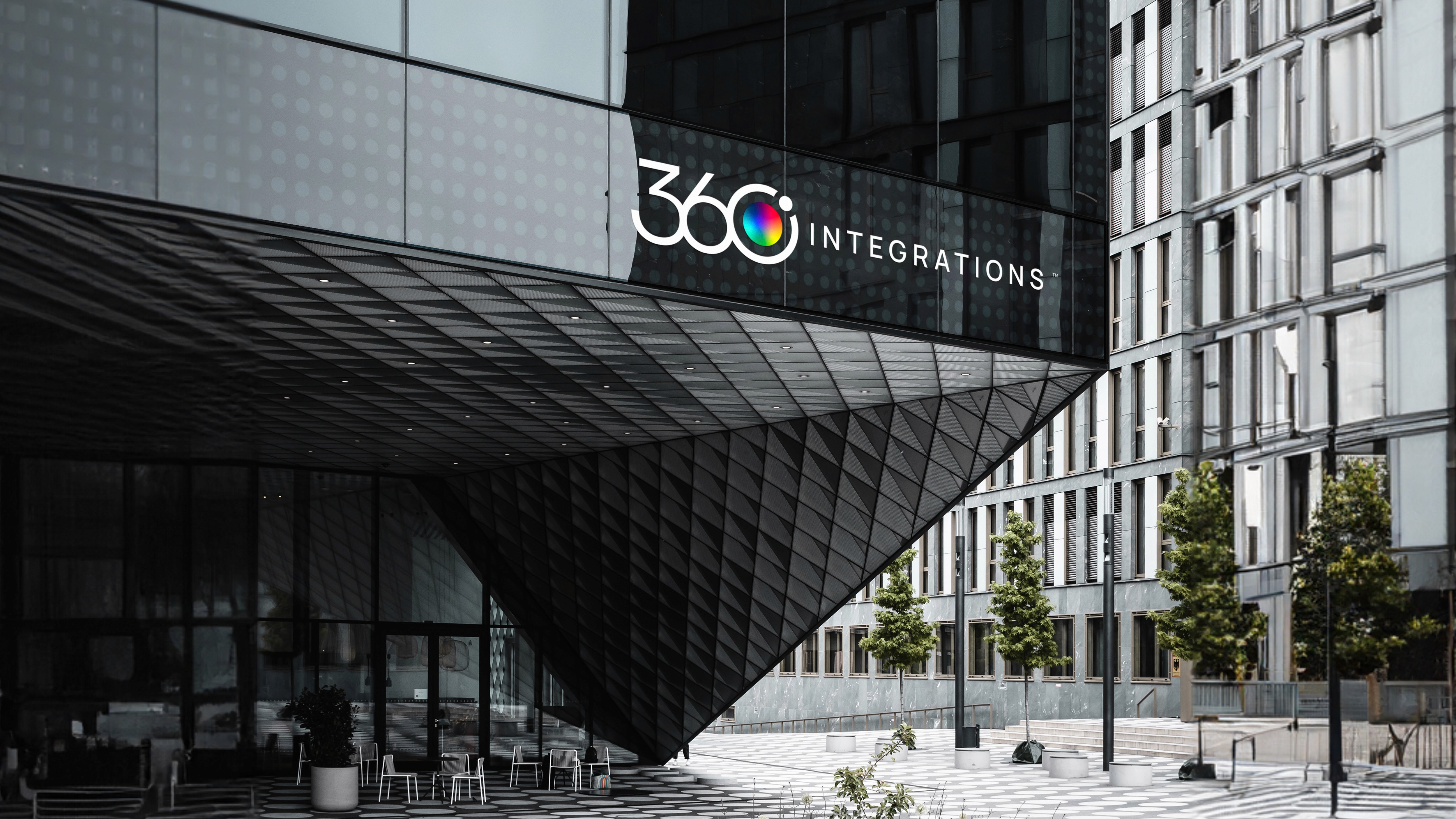 Modern living room with purple sofa, colorful rug, and open shelving