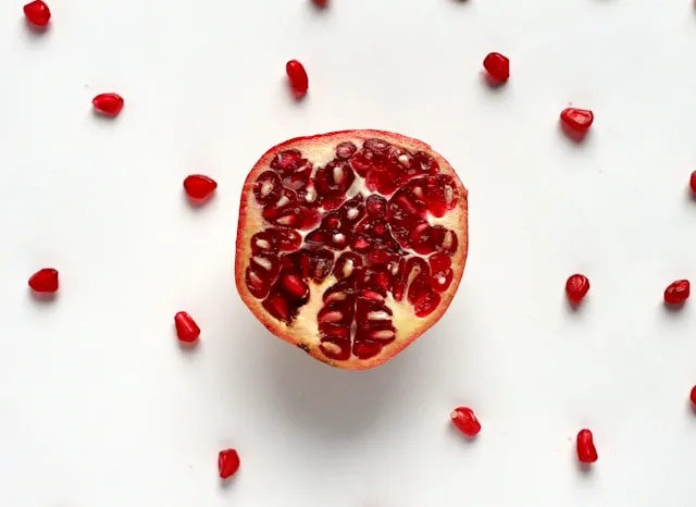 Pomagranate with red seeds on the background