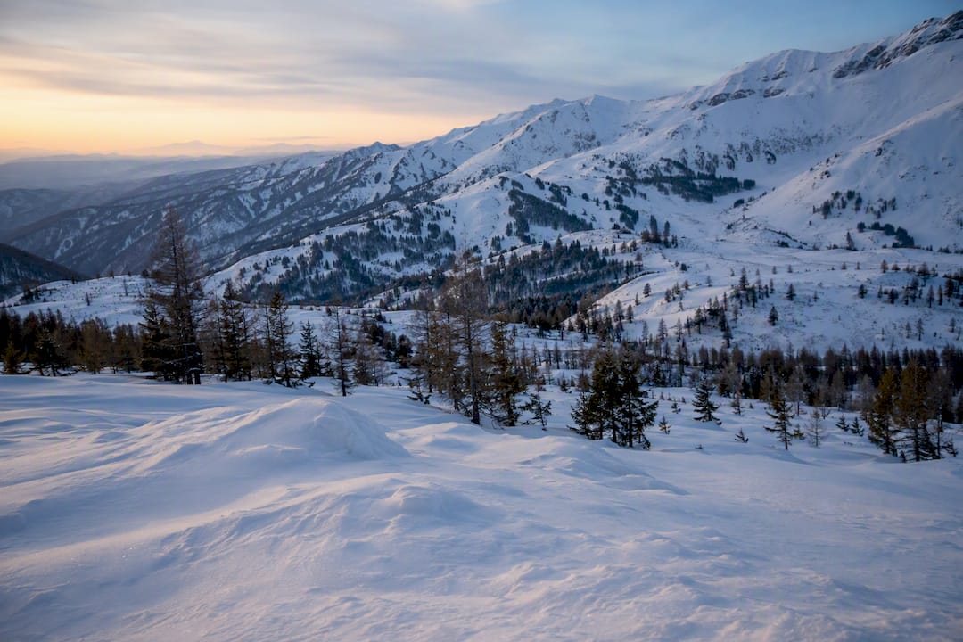 Snow-covered alpine bowl in the Western Altai Mountains