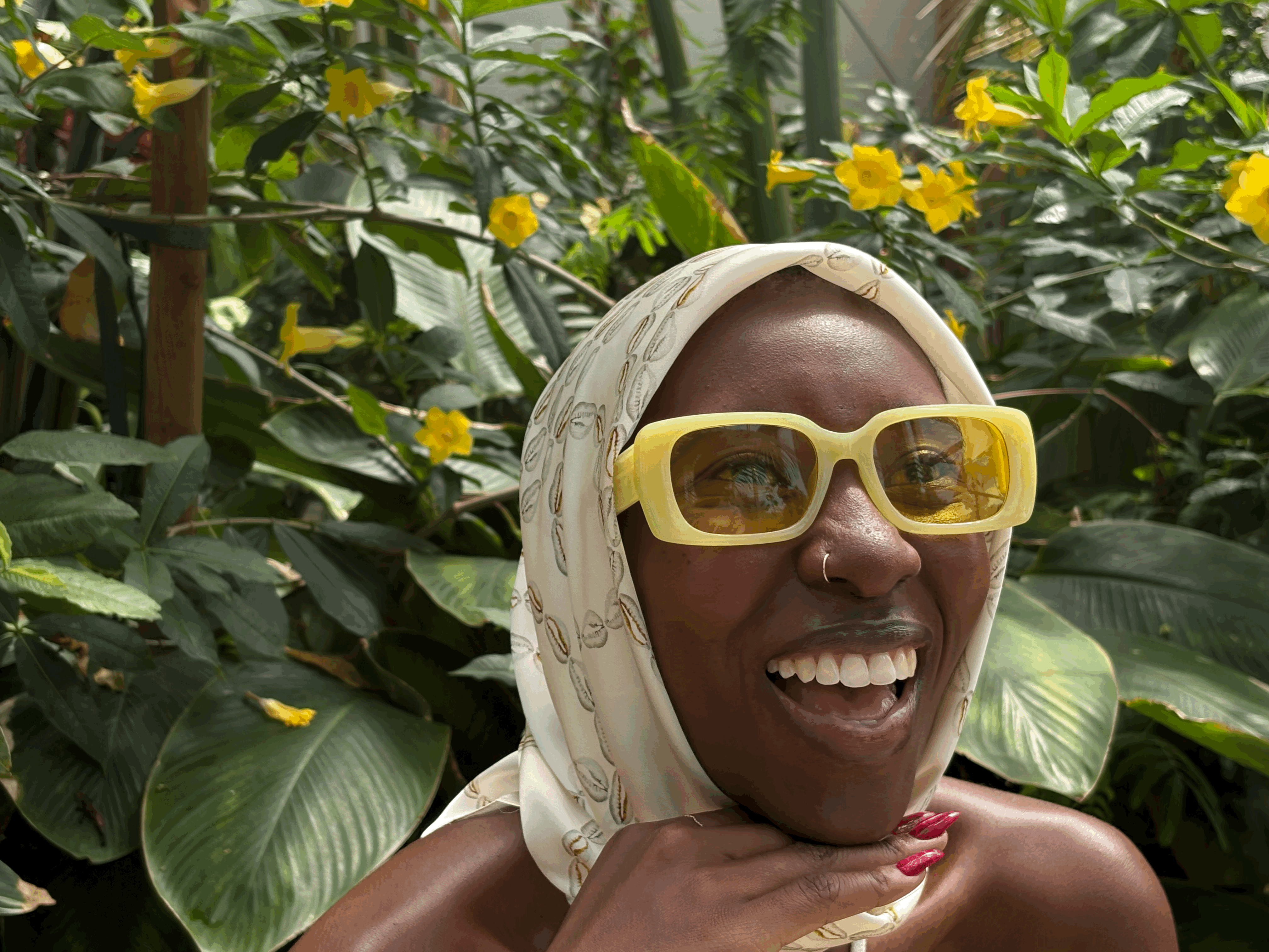 woman in headscarf and glasses smiling