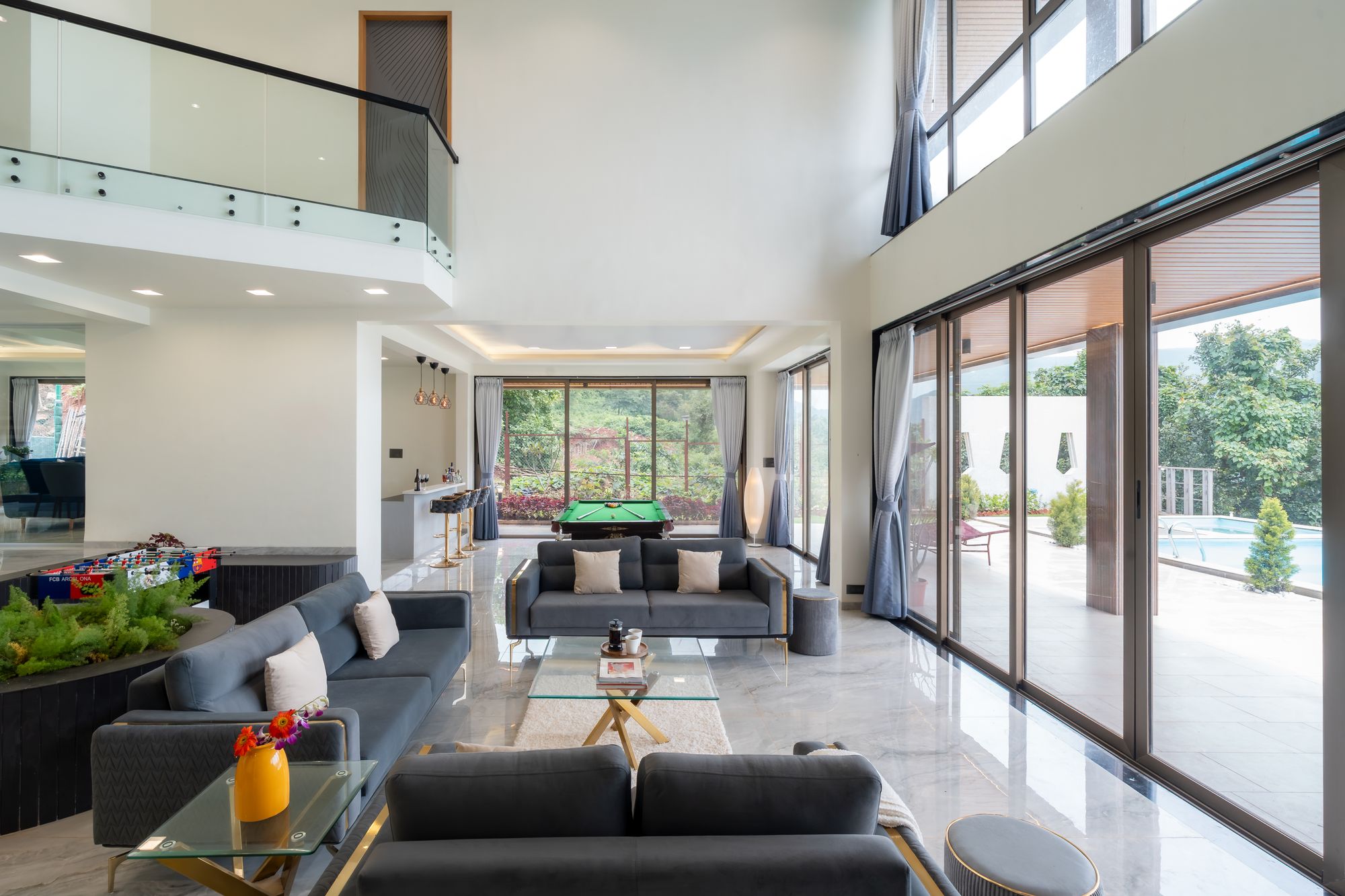 Living room opening through glass walls to the water