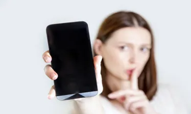 woman holds her quiet phone