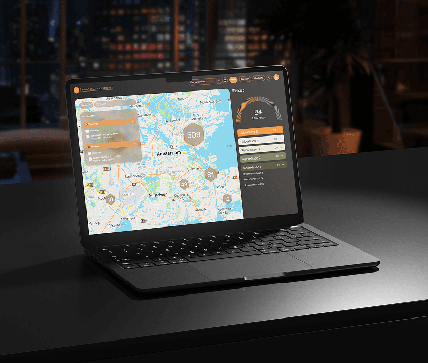 A red hot air balloon glows at sunset over mountains.