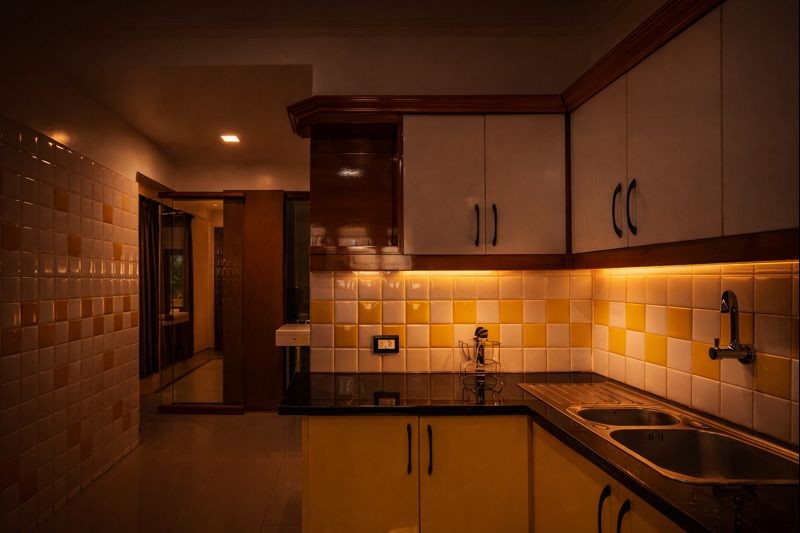 A light-filled fitness space with arched windows inside a coastal Mediterranean-modern villa, facing the ocean. 