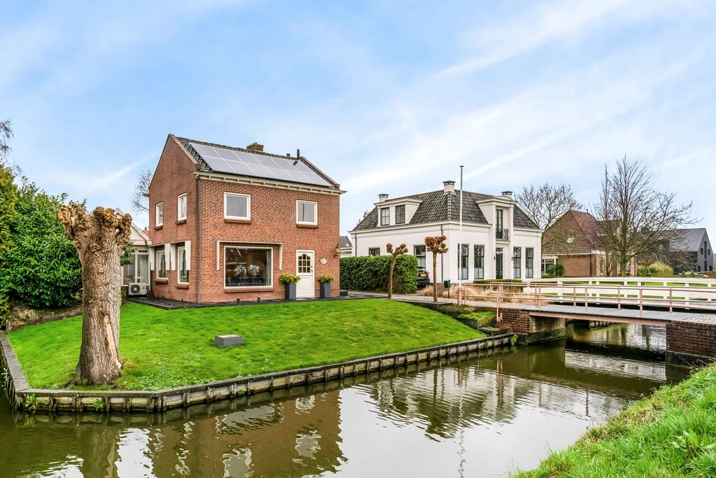 Detached brick houses beside a canal in a Dutch village