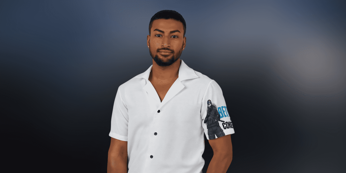 Man wearing white button-up shirt with graphic sleeve design, standing against a dark gradient background.