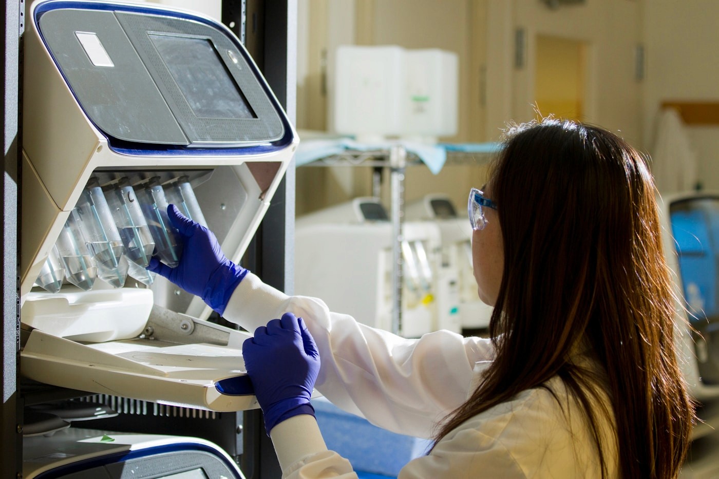 A specialist processing diagnostic samples in a clinical laboratory