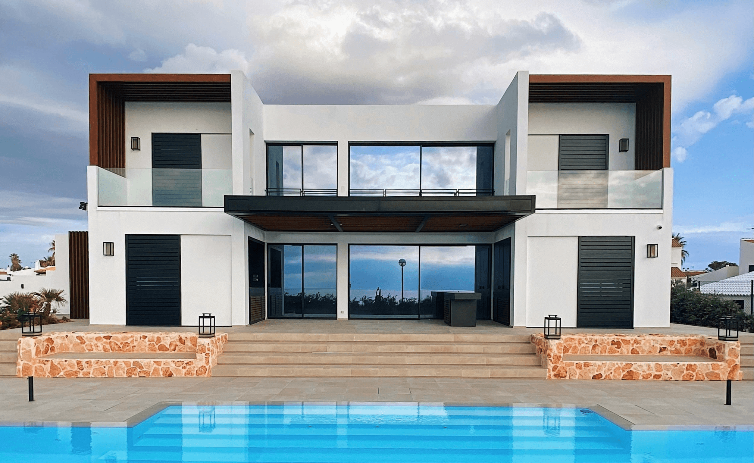 white and brown house near swimming pool