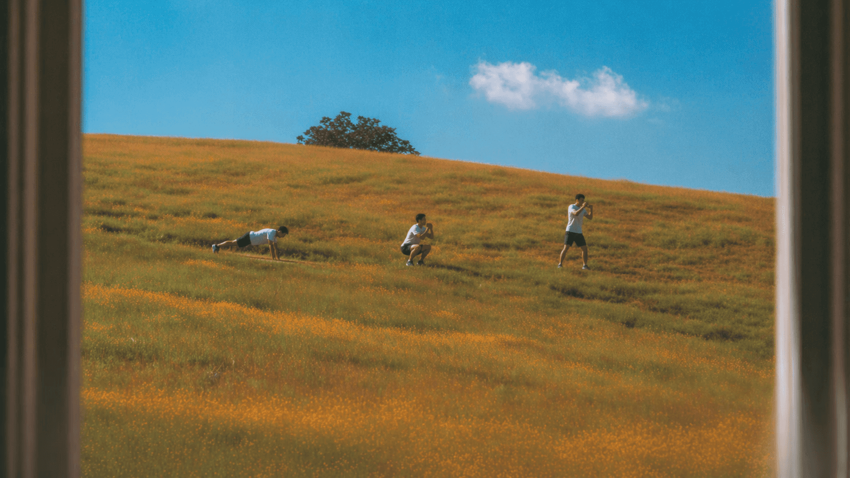 grayscale photo of woman in white shirt and black pants sitting on concrete floor
