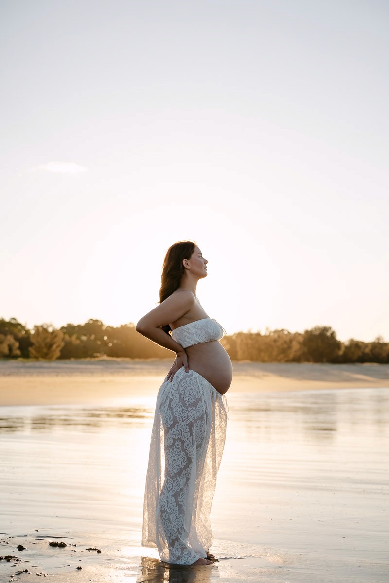 Photograph of pregnant woman at the beach in Mackay