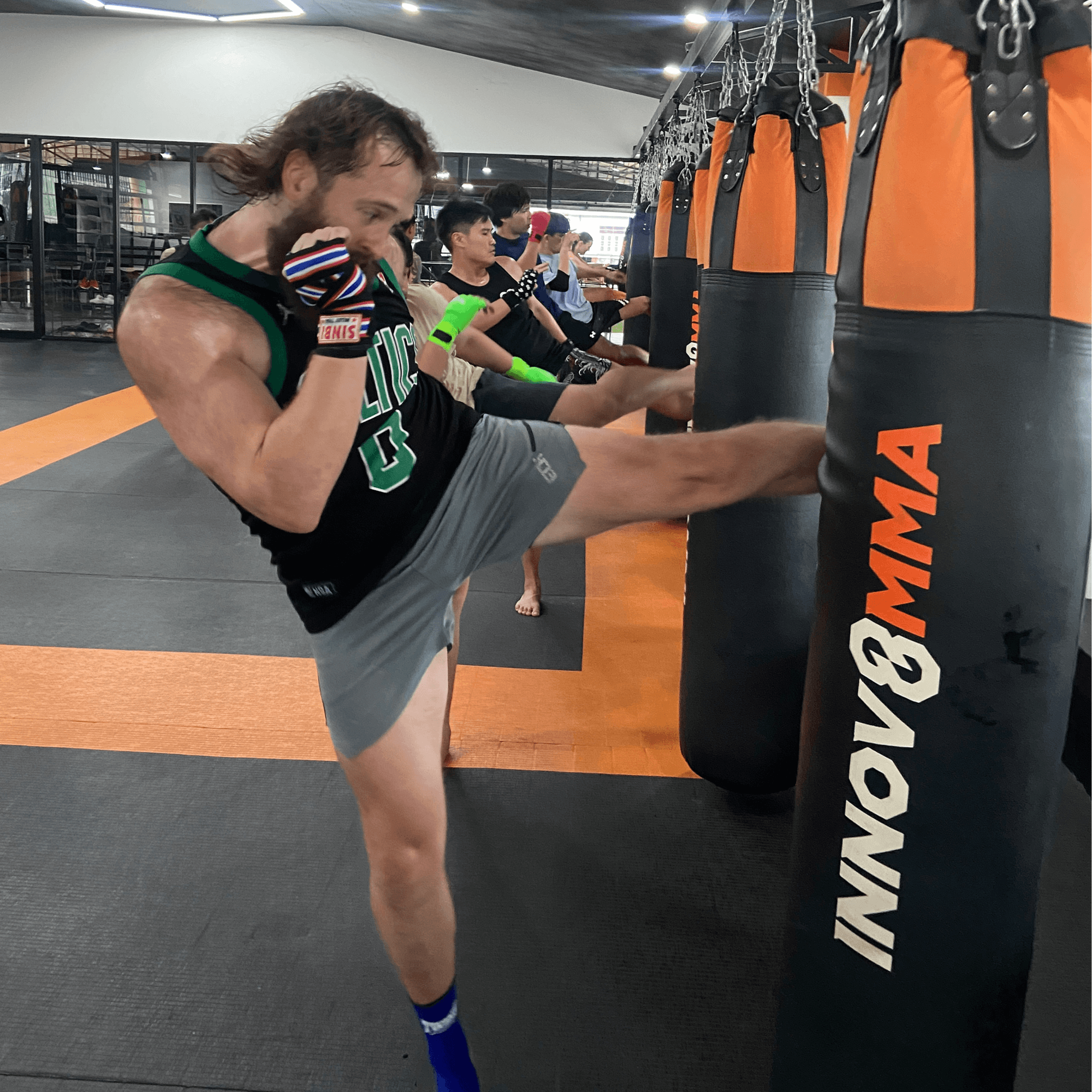 A group of beginner Muay Thai fighters, all ages